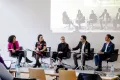 Photo: Panel of five people discussing on a stage