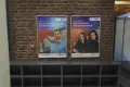 Photo: Posters (advertising frames) on a brick wall in a campus building