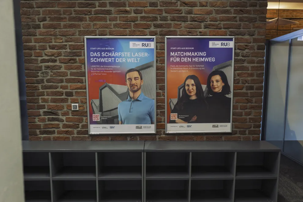 Photo: Posters (advertising frames) on a brick wall in a campus building