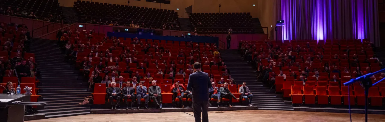 Foto: Rektor steht im Großen Saal des Audimax vor Publikum