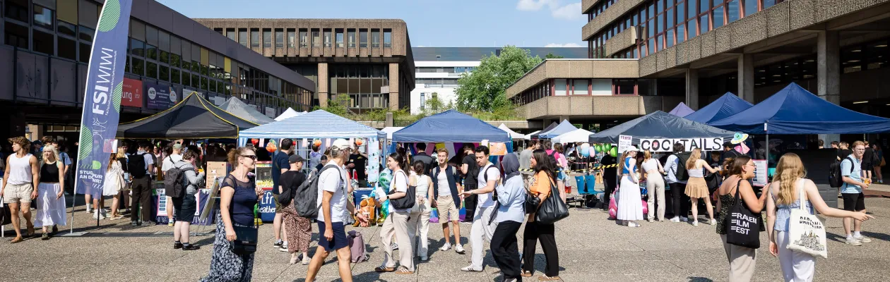 Foto: Stände und Besucherinnen und Besucher bei sonnigem Wetter auf dem Nordforum der Ruhr-Universität Bochum